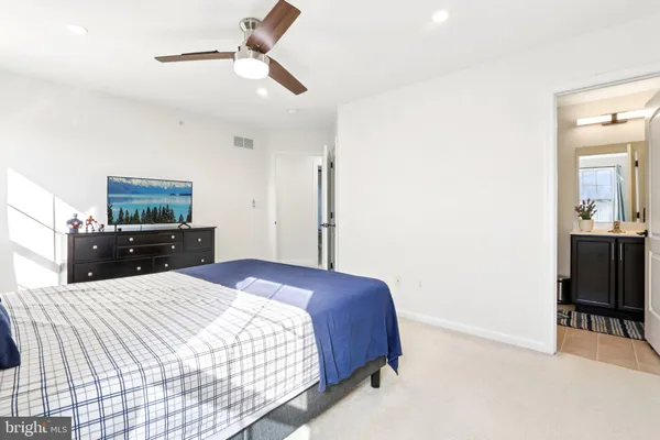 a spacious bedroom with a bed and a couch
