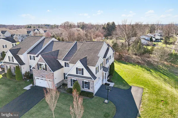 an aerial view of a house with a big yard