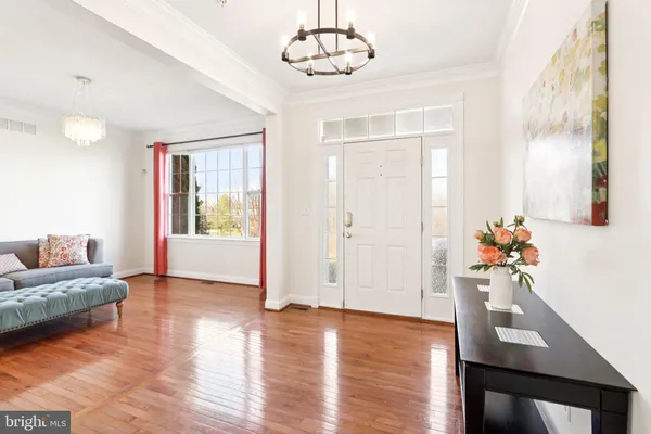 a view of a livingroom with furniture wooden floor and a chandelier