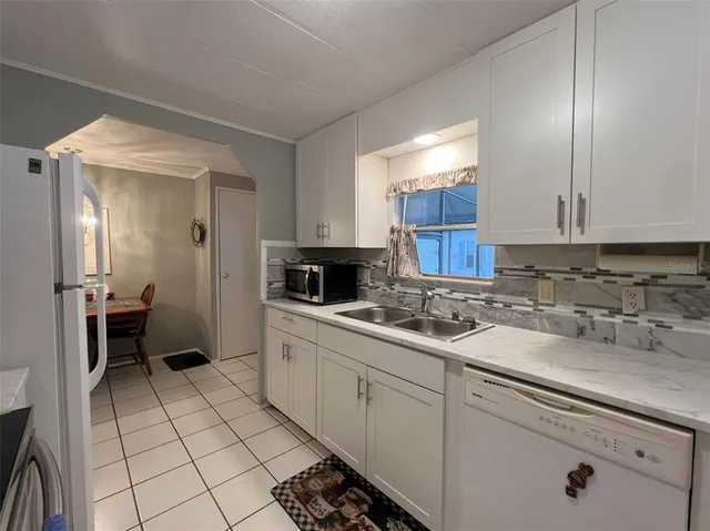 a kitchen with a sink cabinets and window