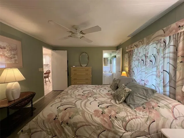 a bedroom with a large bed and a lamp