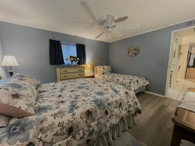 a bedroom with a bed and a ceiling fan