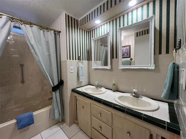 a bathroom with a sink a mirror and a shower