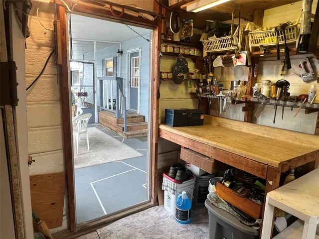 a room with wooden cabinets and stainless steel appliances