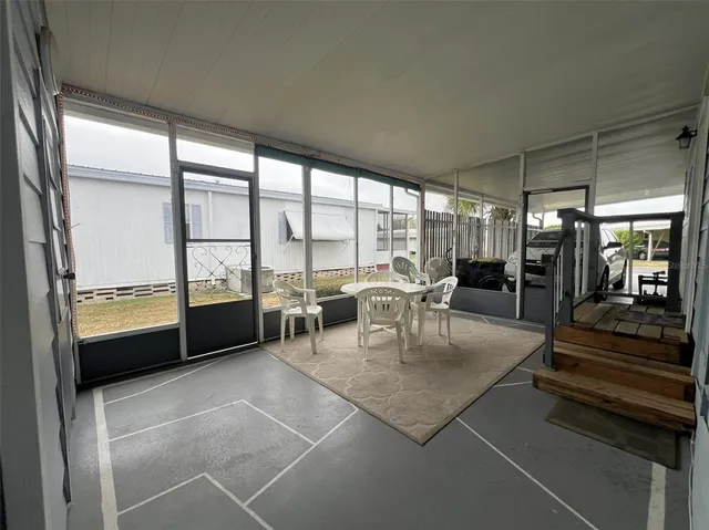 a balcony with chairs and a table