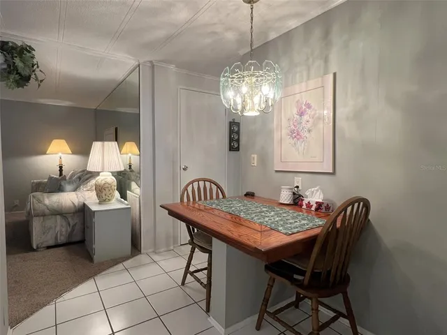 a dining room with furniture and chandelier