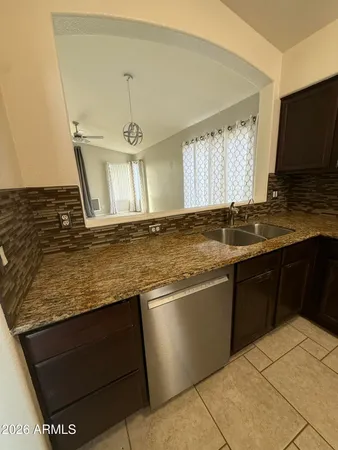 a kitchen with stainless steel appliances granite countertop a sink and a stove