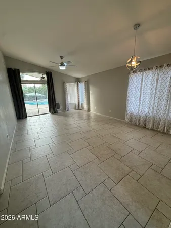 a view of a livingroom with furniture and chandelier fan