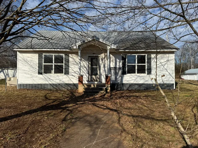 a view of a house with wooden fence