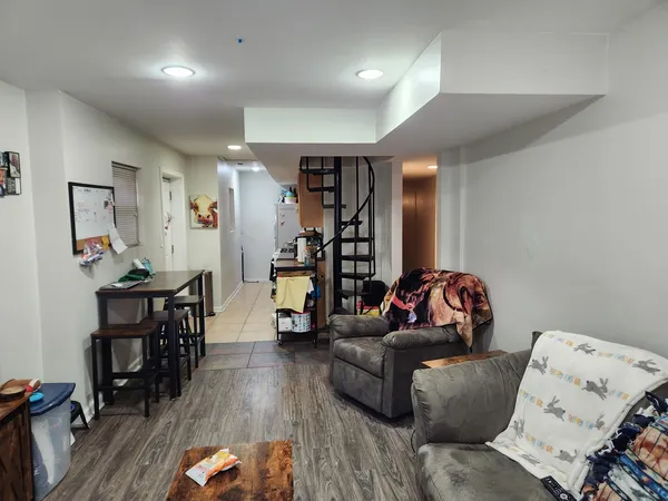a living room with furniture and wooden floor