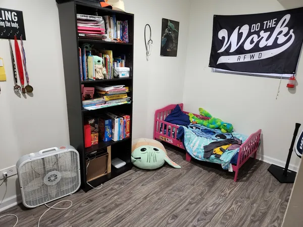 a living room with furniture and book shelf