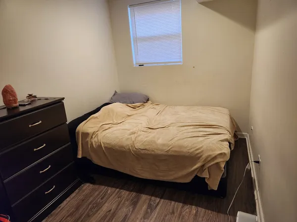 a bedroom with a bed and a window