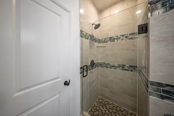 a bathroom with a glass shower door