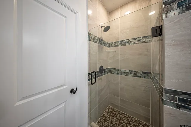 a bathroom with a glass shower door