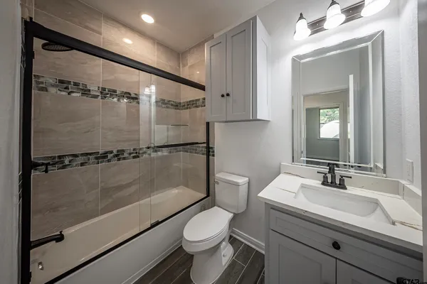 a bathroom with a sink toilet and shower