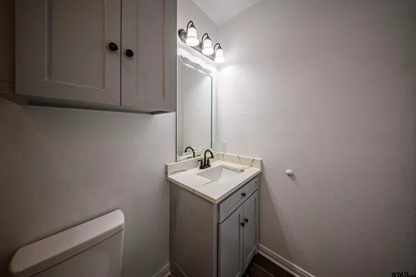 a bathroom with a toilet sink and mirror