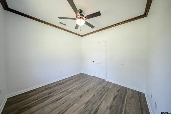 a view of a room with wooden floor