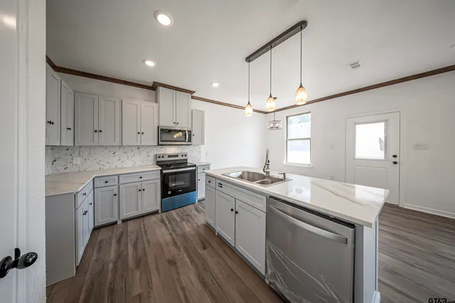 a kitchen with granite countertop white cabinets and white appliances