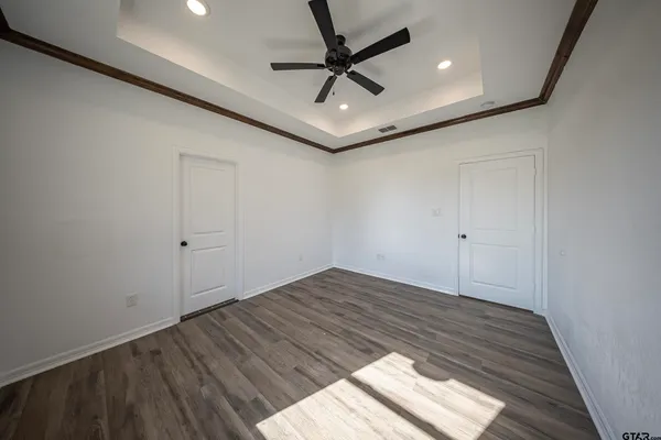 a view of empty room with wooden floor