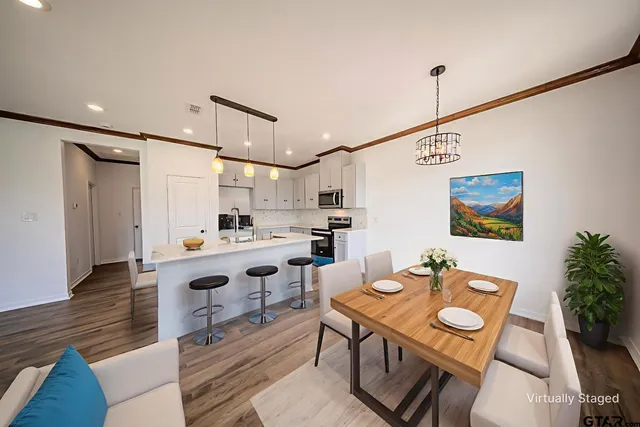 a kitchen with a stove a sink and a refrigerator