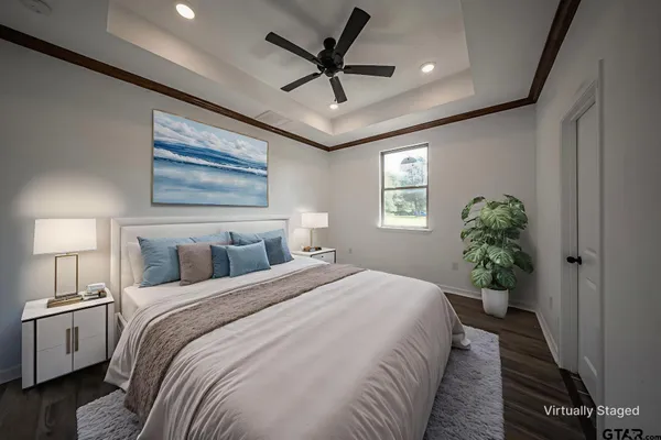 a bedroom with a large bed and a chandelier