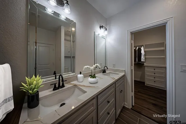 a bathroom with a sink double vanity and a mirror