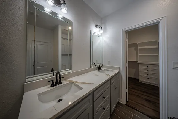 a bathroom with a sink double vanity and a mirror