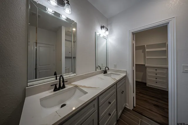 a bathroom with a sink double vanity and a mirror