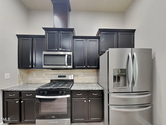 a kitchen with appliances and cabinets