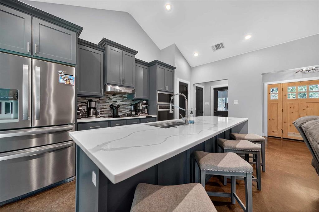 9697 County Road 1405 Athens, TX 75751 - Photo 11 of 38 a kitchen with a table chairs stainless steel appliances and cabinets