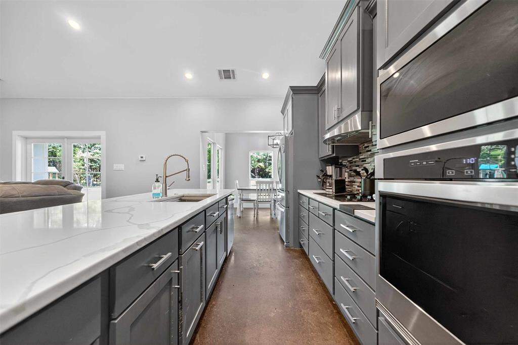 9697 County Road 1405 Athens, TX 75751 - Photo 37 of 38 a kitchen with stainless steel appliances granite countertop sink stove and cabinets