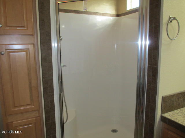 550 Raspberry Place, Unit 38 Oxnard, CA 93036 - Photo 22 of 43 a bathroom with a glass shower door