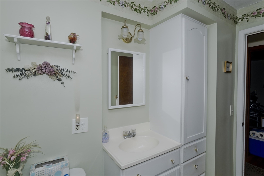 129 Cooper Street Springfield, MA 01108 - Photo 17 of 26 a bathroom with a sink and a mirror