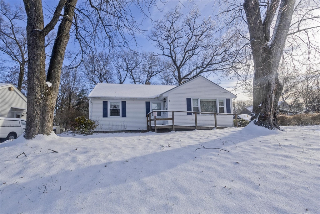 129 Cooper Street Springfield, MA 01108 - Photo 25 of 26 a front view of a house with a dirt yard and a large tree