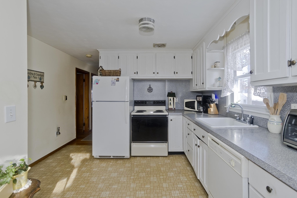129 Cooper Street Springfield, MA 01108 - Photo 5 of 26 a kitchen with white cabinets and white appliances