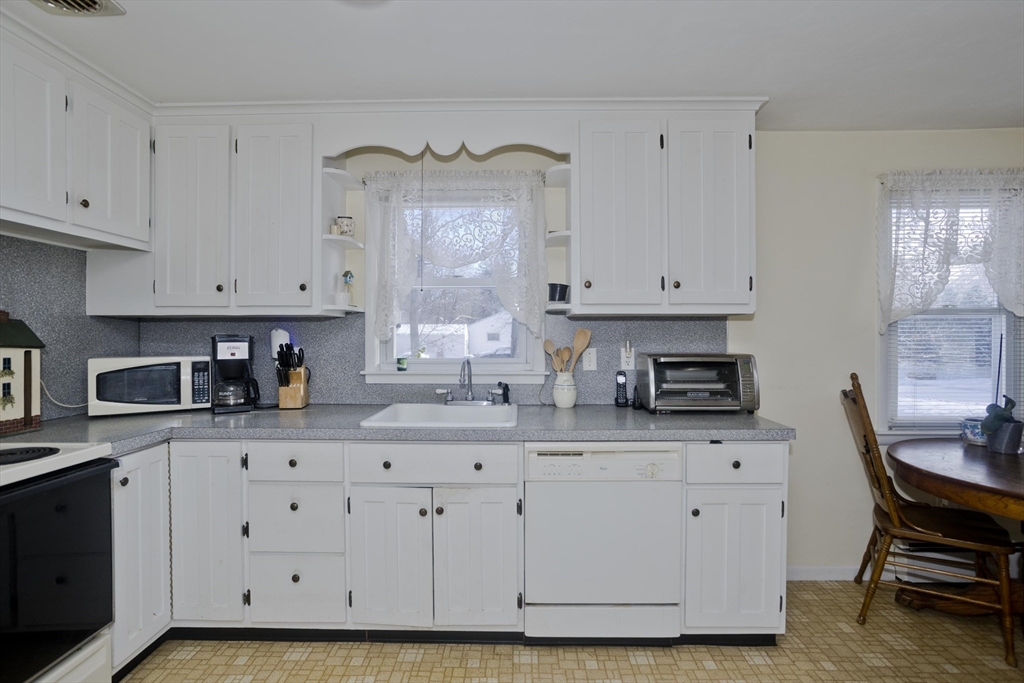 129 Cooper Street Springfield, MA 01108 - Photo 8 of 26 a kitchen with stainless steel appliances granite countertop a sink a stove and cabinets