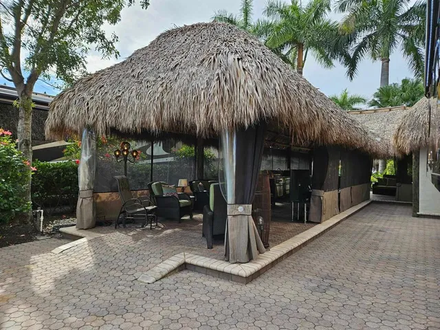a view of a house with a patio and a yard
