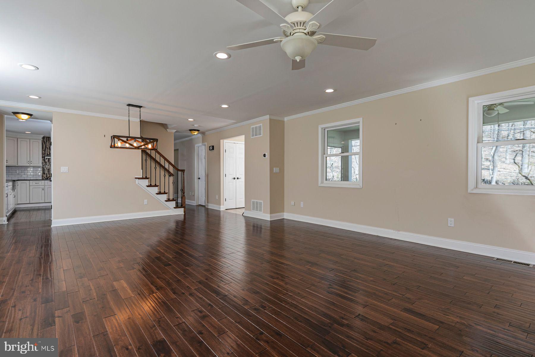 310 Hollow Road Skillman, NJ 08558 - Photo 8 of 32 a view of an empty room with wooden floor and a ceiling fan