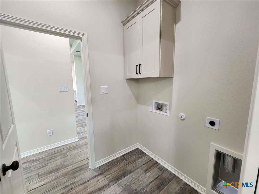 406 Talon Loop Salado, TX 76571 - Photo 27 of 31 an empty room with wooden floor and cabinet