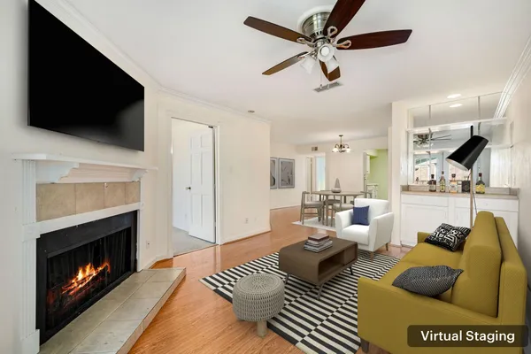 a living room with furniture a fireplace and a flat screen tv