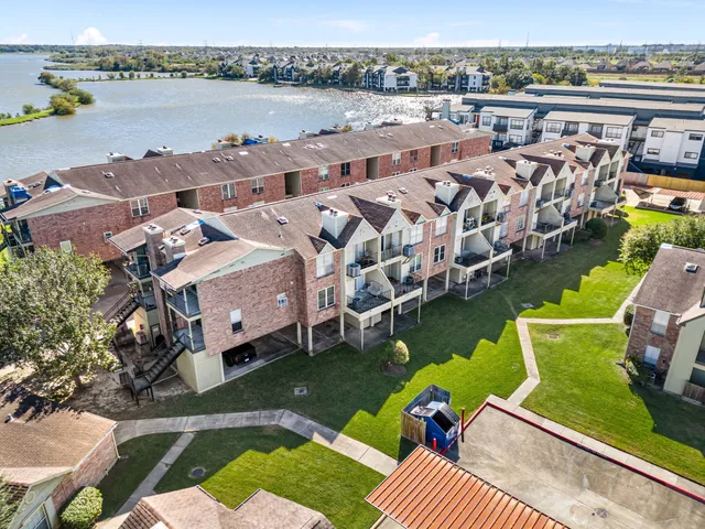 a view of empty room with wooden floor and fireplace