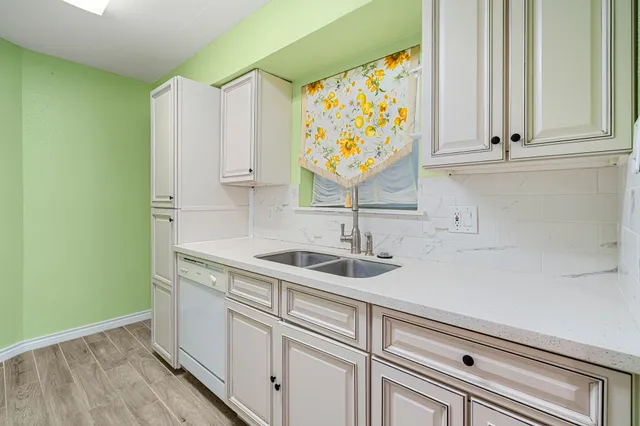 a spacious bedroom with a bed and a chandelier