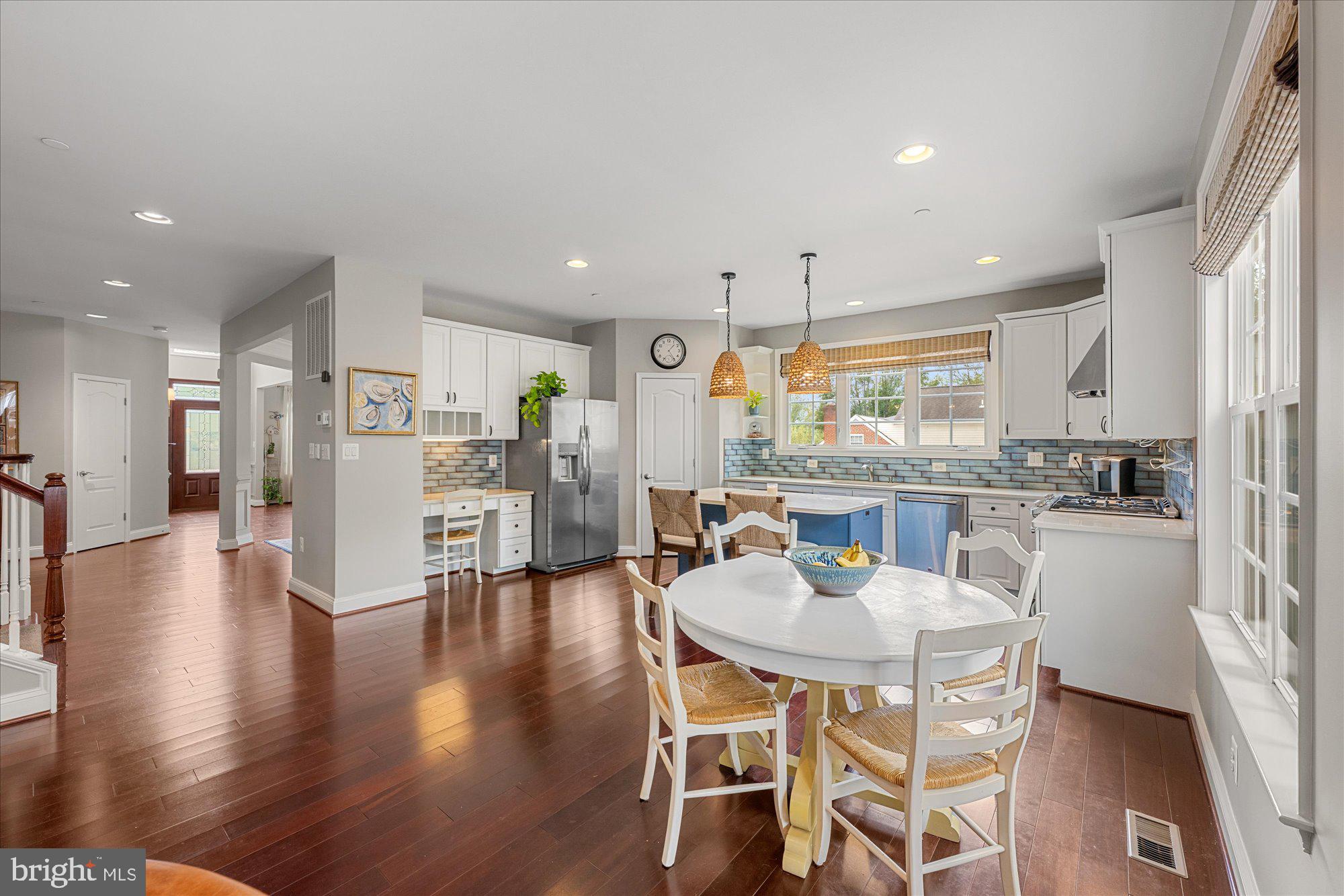 8808 Walnut Hill Road Chevy Chase, MD 20815 - Photo 19 of 60 a kitchen with stainless steel appliances kitchen island granite countertop a dining table chairs and view living room