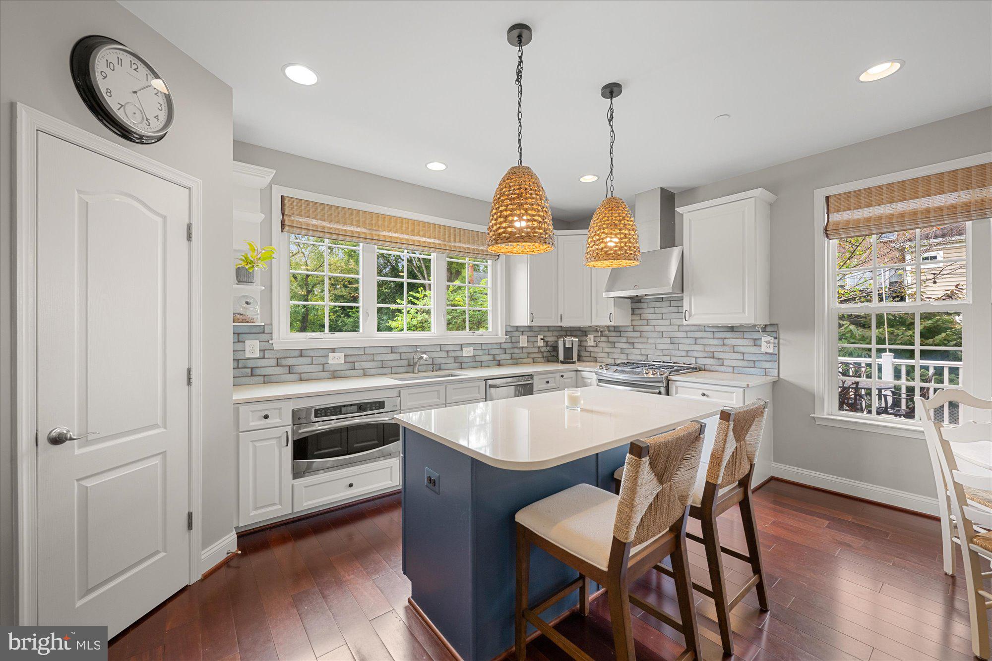 8808 Walnut Hill Road Chevy Chase, MD 20815 - Photo 20 of 60 a kitchen with a sink a stove a dining table and chairs