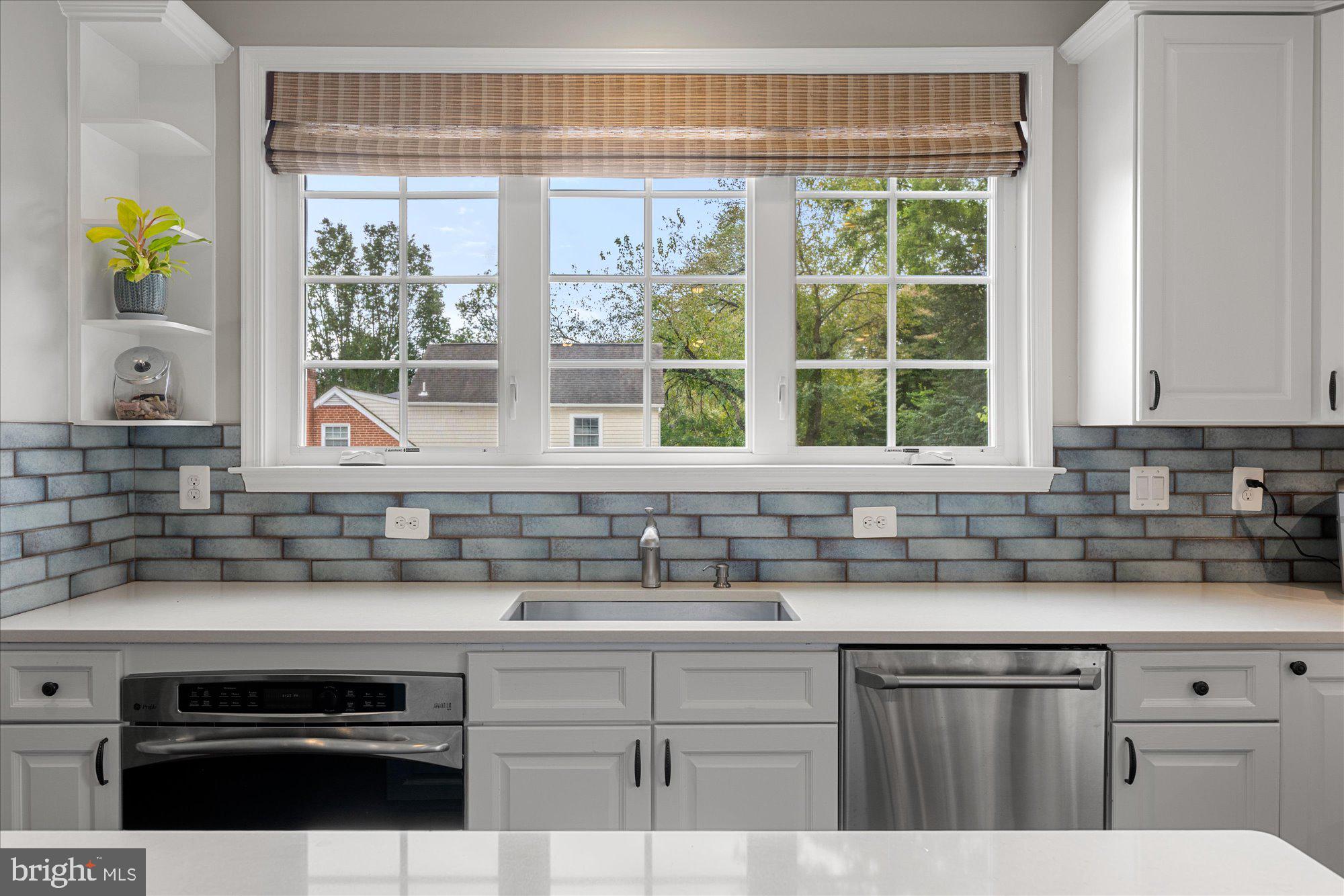 8808 Walnut Hill Road Chevy Chase, MD 20815 - Photo 21 of 60 a kitchen with stainless steel appliances granite countertop a sink a stove and a granite counter tops