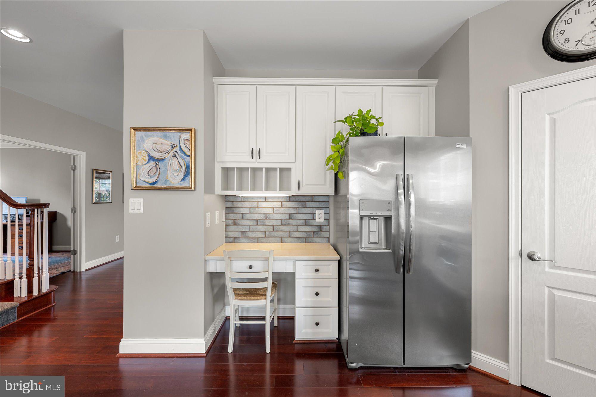8808 Walnut Hill Road Chevy Chase, MD 20815 - Photo 22 of 60 a kitchen with granite countertop a refrigerator and a stove top oven