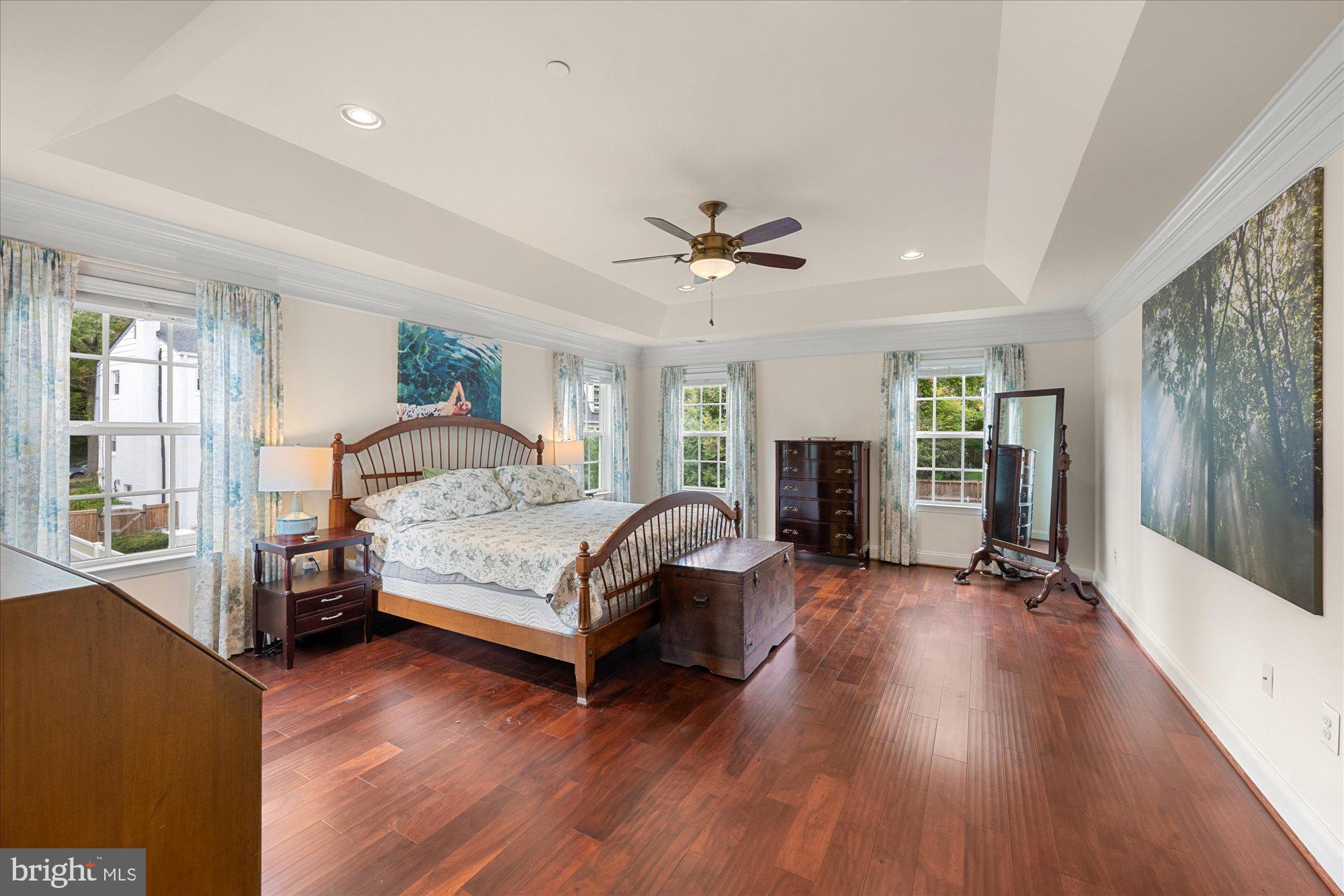 8808 Walnut Hill Road Chevy Chase, MD 20815 - Photo 28 of 60 a bedroom with a bed wooden floor and a fireplace