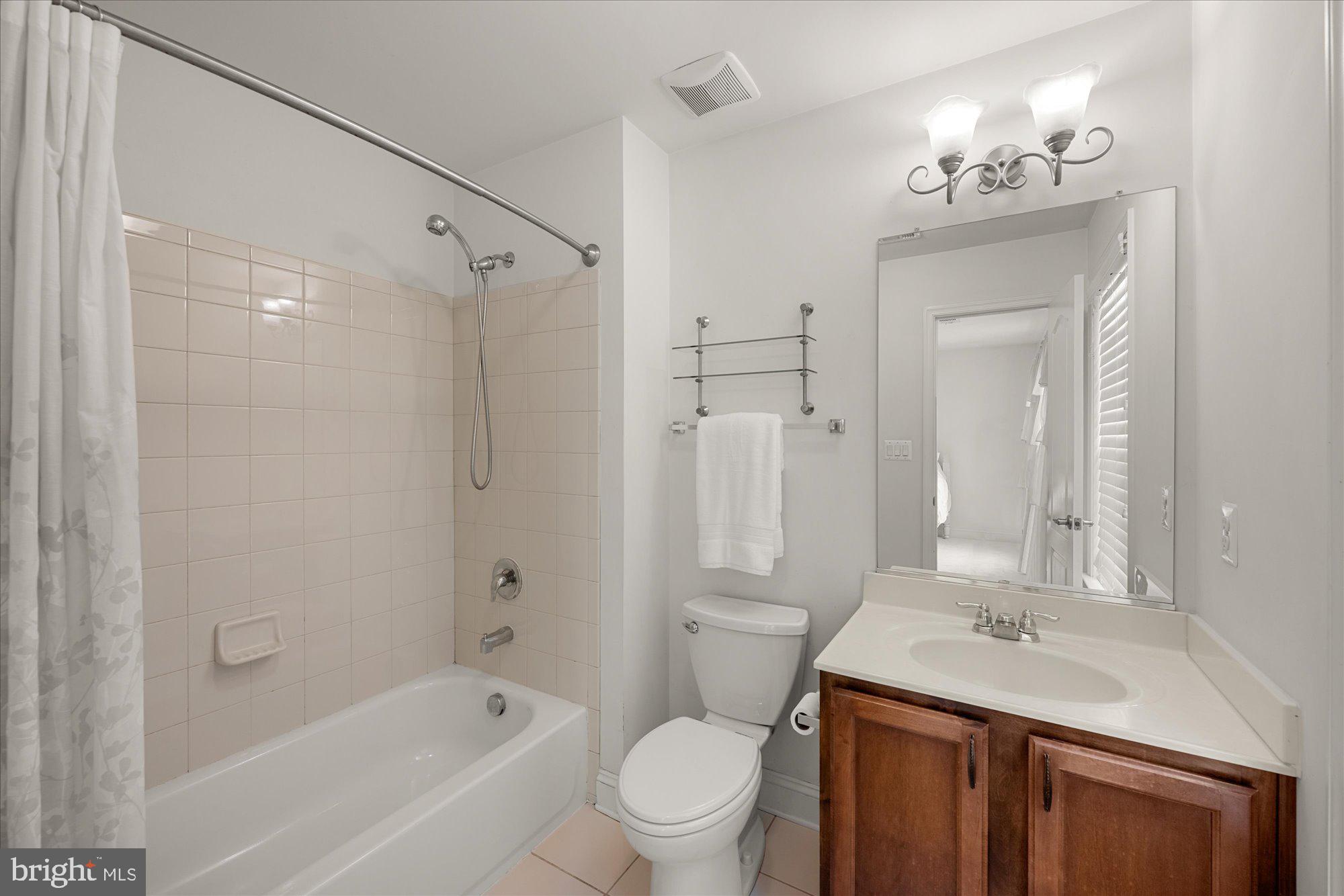 8808 Walnut Hill Road Chevy Chase, MD 20815 - Photo 35 of 60 a bathroom with a granite countertop sink mirror toilet and bathtub