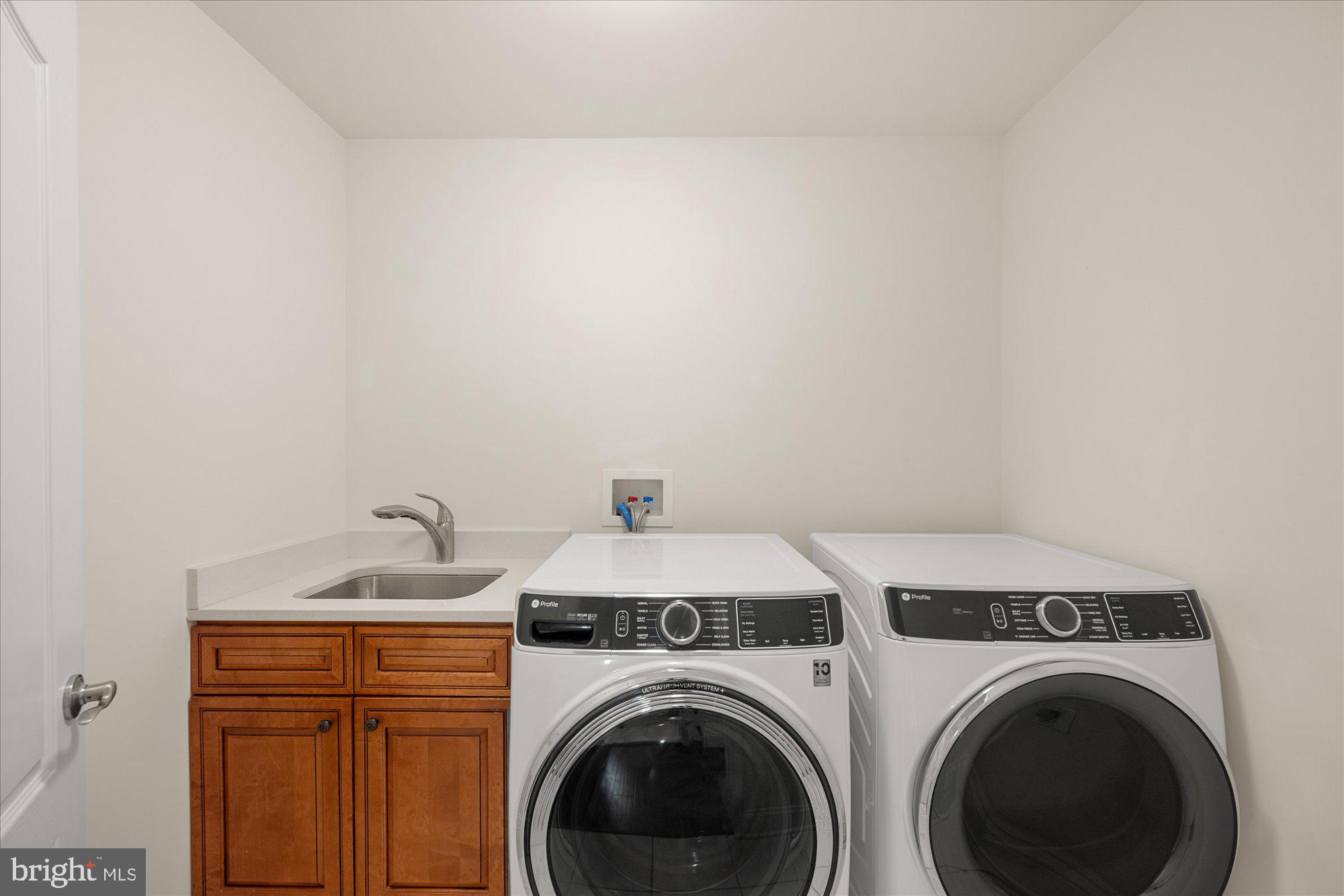 8808 Walnut Hill Road Chevy Chase, MD 20815 - Photo 40 of 60 a utility room with dryer and washer