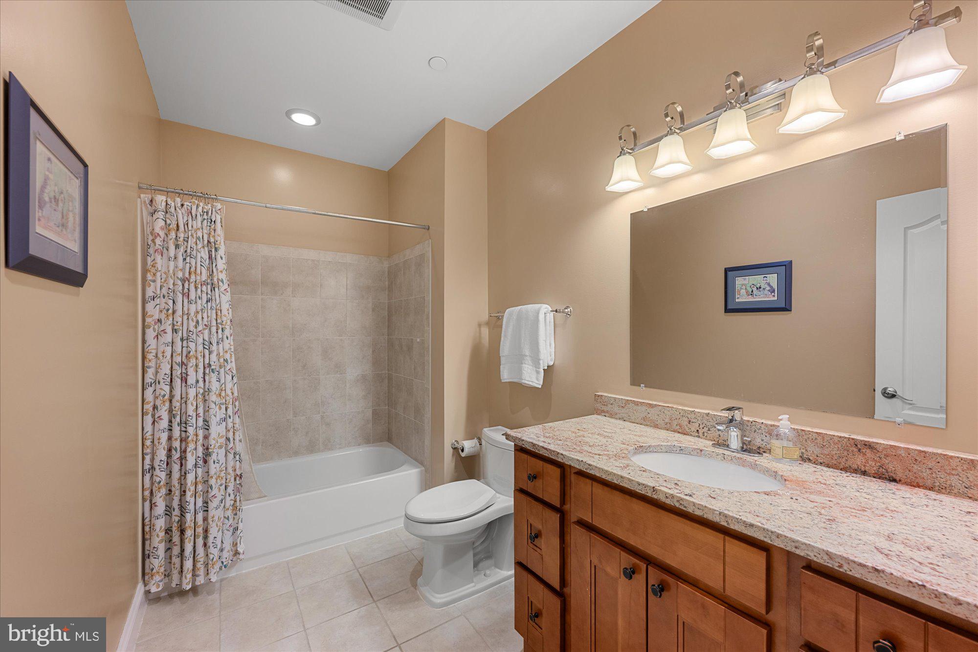 8808 Walnut Hill Road Chevy Chase, MD 20815 - Photo 46 of 60 a bathroom with a granite countertop sink a toilet and shower